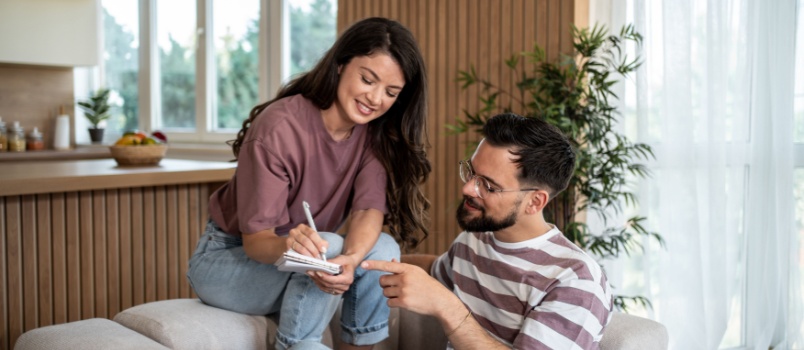 couple writing on notepad