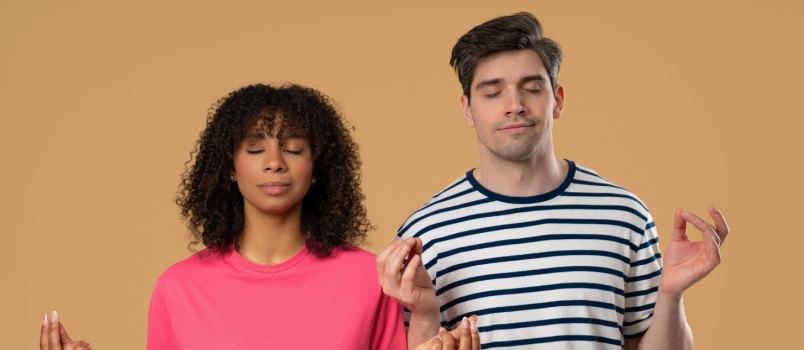calm relaxing couple doin meditation