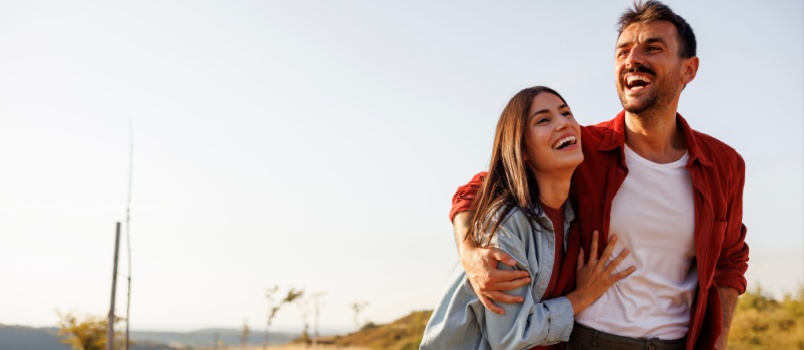 Beautiful couple having fun while hiking