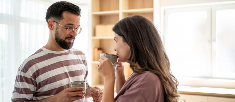 young couple talking while having coffee