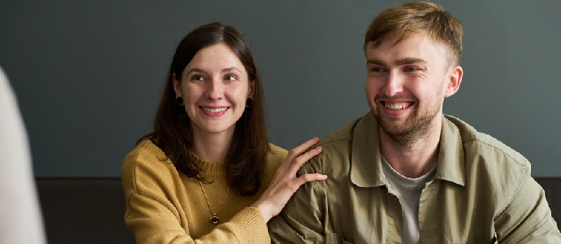 Happy couple talking to therapist