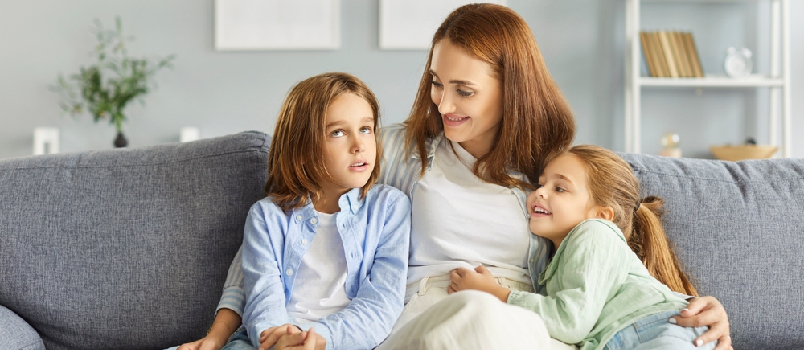 Young smiling mother talking to her kids
