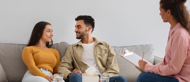 couple sitting on couch engaging with each other