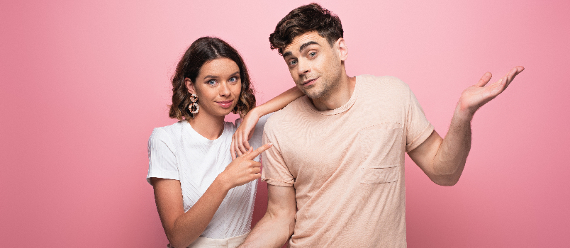 Smiling Man and Woman Posing on Pink Background