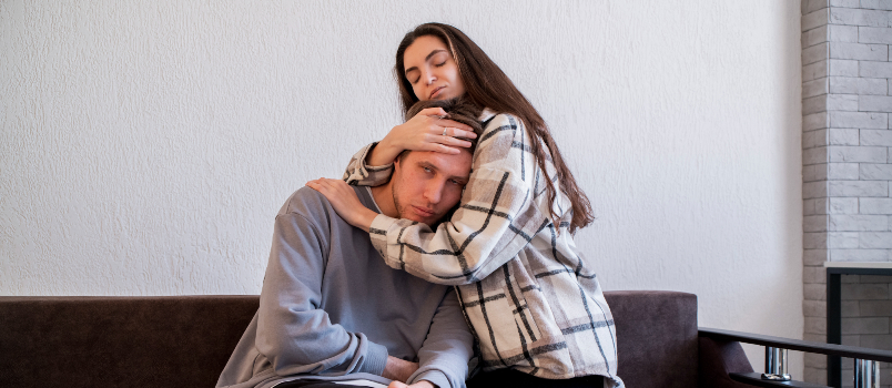 Woman comforting man