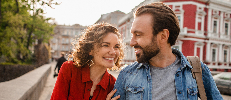 Affectionate Couple Strolling Together Through Urban Cityscape