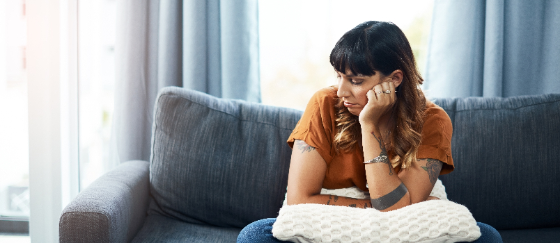 Woman Sitting on a Couch in Disappointment