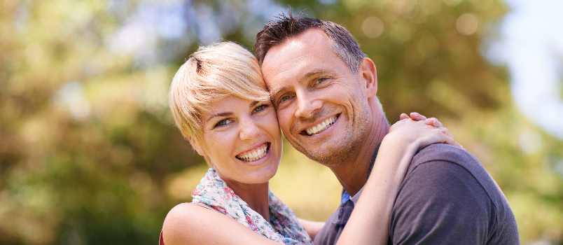 Loving Couple Embraces in a Green Park 