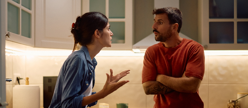 Woman Arguing with Man in Kitchen Setting