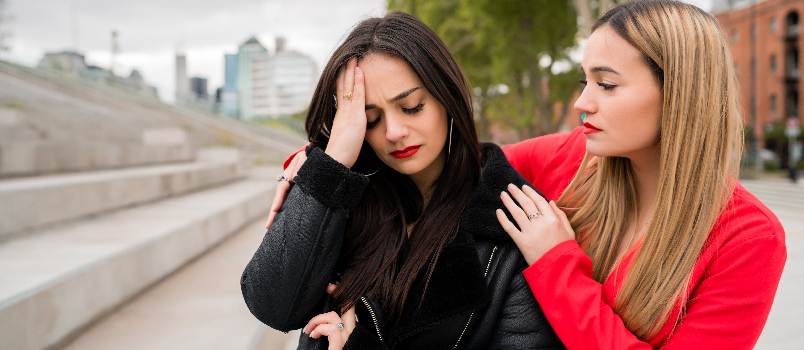 Woman Comforting Her Friend in Outdoor Urban Area