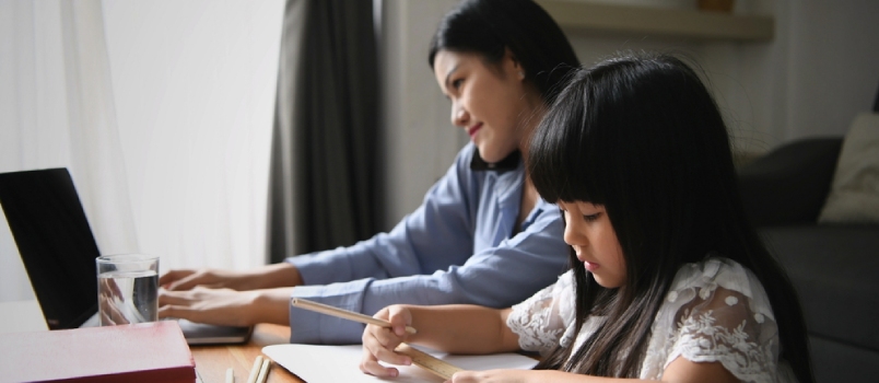 Mom is Working and Daughter is Playing With Pencil